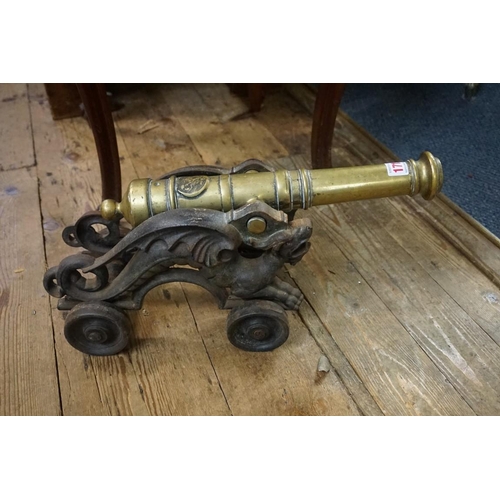 1719 - A large brass and steel model cannon, on four wheel carriage, the cannon 38cm long.