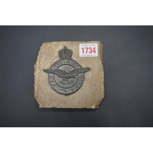 1734 - A cast metal RAF badge, on sandstone mount, 12cm wide.