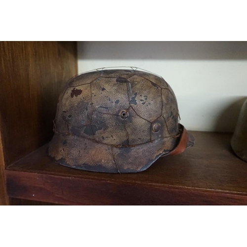 1810 - A German World War II M35 Heer Stahlhelm chickenwire helmet, with liner, inscribed 'Vogts' to interi... 