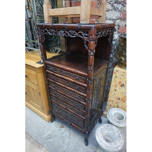 1074 - A late 19th/early 20th century Chinese carved hardwood side cabinet, with an open tier above six lon... 