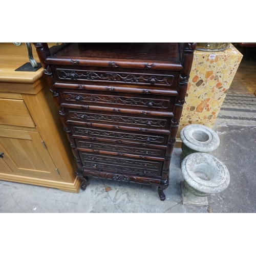 1074 - A late 19th/early 20th century Chinese carved hardwood side cabinet, with an open tier above six lon... 