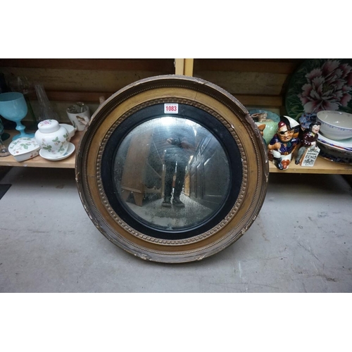 1083 - An antique giltwood framed convex wall mirror, 46cm diameter. 