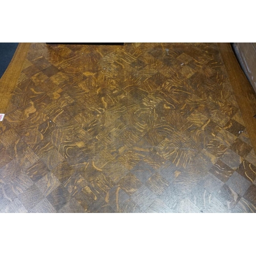 1424 - An early 20th century French oak parquetry dining table, 138cm.  