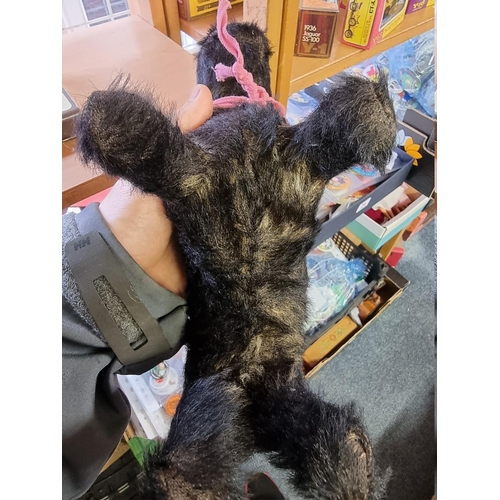 21 - A vintage black mohair Terrier, straw filled with glass eyes, 26cm long.