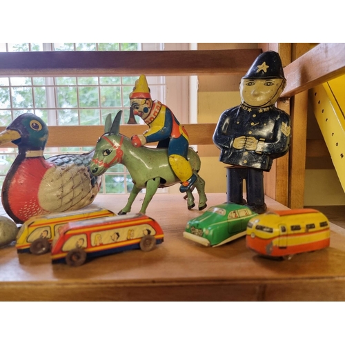 27 - Tinplate: a collection of wind-up tinplate toys, to include two 'Made in US Zone' ducks; another sma... 