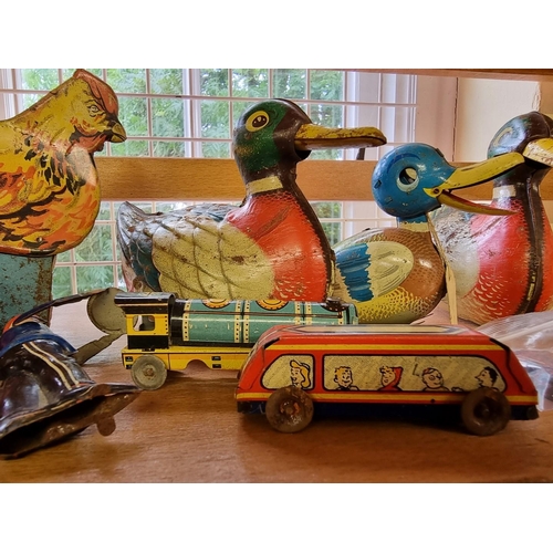 27 - Tinplate: a collection of wind-up tinplate toys, to include two 'Made in US Zone' ducks; another sma... 