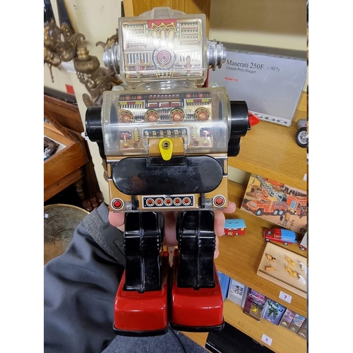 3 - Robots: a vintage (circa 1970s) battery operated 'Piston' robot, possibly by Horikawa, with remains ... 