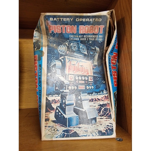 3 - Robots: a vintage (circa 1970s) battery operated 'Piston' robot, possibly by Horikawa, with remains ... 