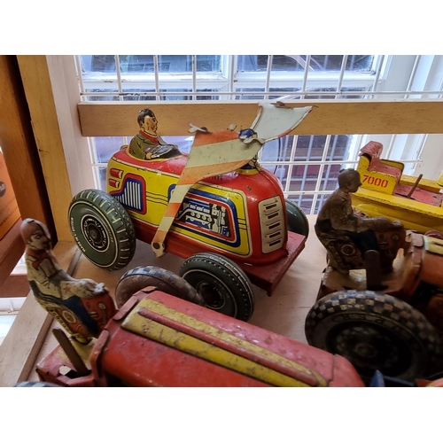 50 - Tinplate: four vintage tinplate tractors; together with other tinplate and diecast vehicles; to incl... 