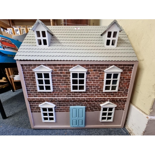 89 - A modern wooden dolls house, 61cm wide x 67cm high x 38cm deep.