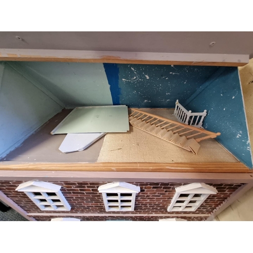 89 - A modern wooden dolls house, 61cm wide x 67cm high x 38cm deep.