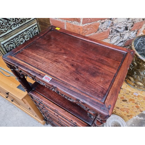 1074 - A late 19th/early 20th century Chinese carved hardwood side cabinet, with an open tier above six lon... 