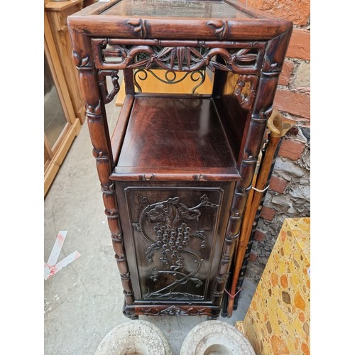 1074 - A late 19th/early 20th century Chinese carved hardwood side cabinet, with an open tier above six lon... 