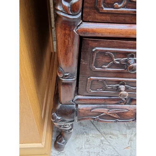 1074 - A late 19th/early 20th century Chinese carved hardwood side cabinet, with an open tier above six lon... 