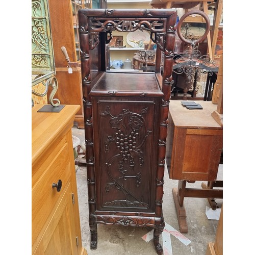 1074 - A late 19th/early 20th century Chinese carved hardwood side cabinet, with an open tier above six lon... 