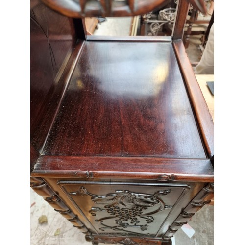 1074 - A late 19th/early 20th century Chinese carved hardwood side cabinet, with an open tier above six lon... 