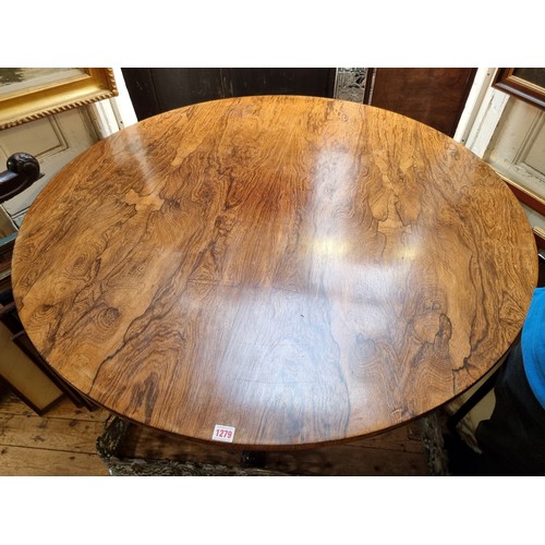 1279 - A mid 19th century rosewood circular tilt top breakfast table, 122cm diameter.