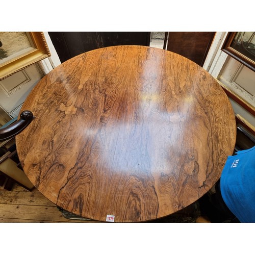 1279 - A mid 19th century rosewood circular tilt top breakfast table, 122cm diameter.