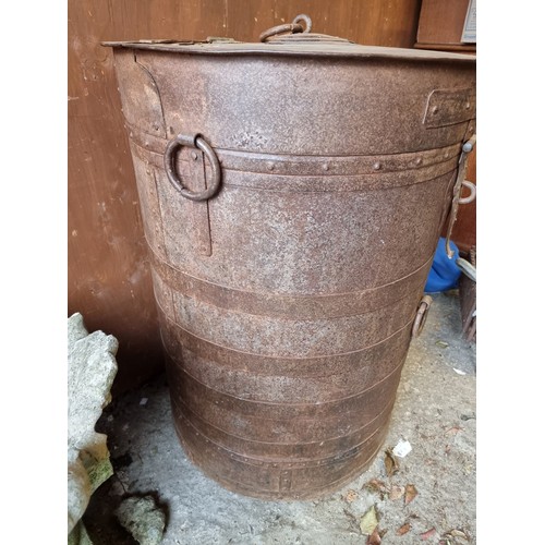 1022 - A large metal animal feed barrel, 65cm wide x 88cm high. 