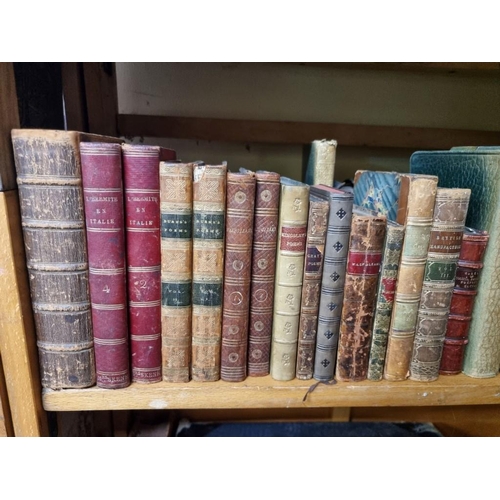 145 - BINDINGS: a quantity of leather bound books over 3 shelves. 