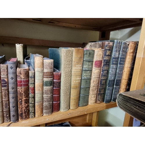 145 - BINDINGS: a quantity of leather bound books over 3 shelves. 