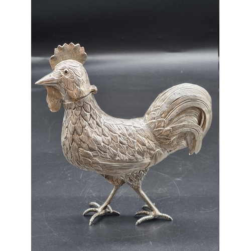 511 - A continental white metal cockerel, the hinged head revealing a pierced cover, 344g, 20.5cm high.... 