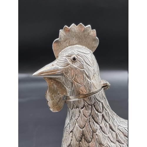 511 - A continental white metal cockerel, the hinged head revealing a pierced cover, 344g, 20.5cm high.... 