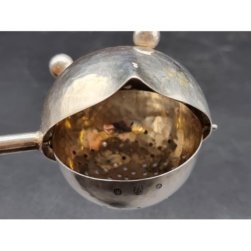 520 - A Danish hammered silver tea strainer, by Johannes Siggaard, circa 1933, 67g all in, 18cm long.... 