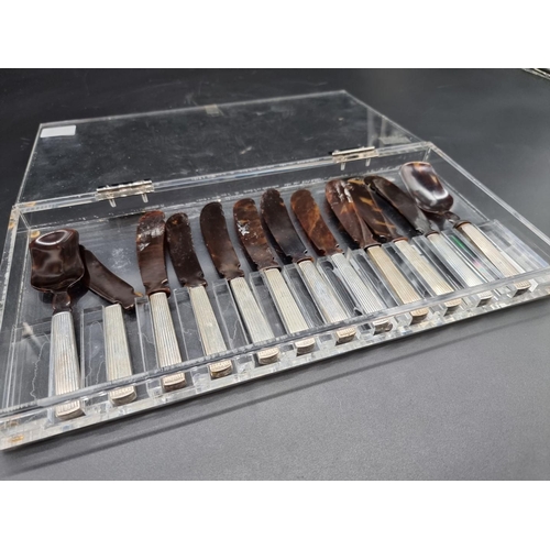 553 - *WITHDRAWN FROM SALE* A cased set of ten tortoiseshell caviar knives and two spoons, stamped 'A W 92... 