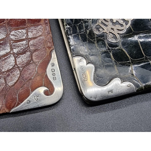 607 - A set of three silver mounted crocodile skin wallets, largest 15.5 x 10cm; together with another sim... 