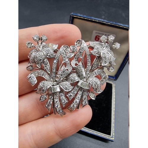 675 - An Art Deco style diamond and white metal metamorphic floral brooch, separating to form a pair of br... 