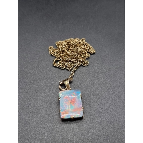 679 - A yellow metal and opal pendant, 18mm high, on a yellow metal chain stamped '375' to clasp, 65cm.... 