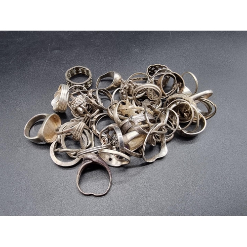 733 - A quantity of silver and white metal rings, some gem set.