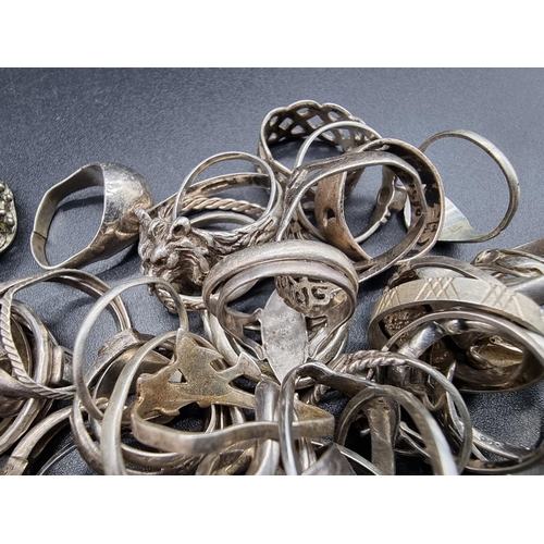 733 - A quantity of silver and white metal rings, some gem set.