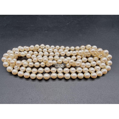 740 - A cultured pearl necklace, of 146 pearls, each approximately 8mm diameter, the unmarked clasp pave s... 