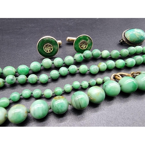 743 - A graduated jadeite bead necklace, 80cm; together with a pair of Chinese jade set gold plated sterli... 