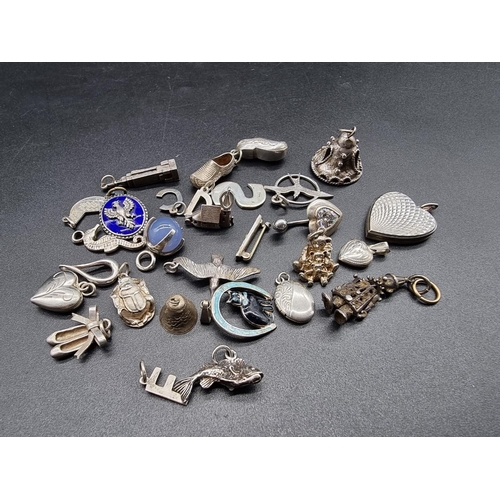 745 - A small quantity of silver and white metal charms and similar.