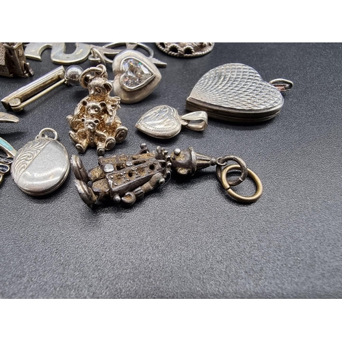 745 - A small quantity of silver and white metal charms and similar.