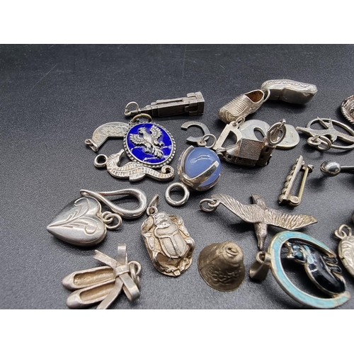 745 - A small quantity of silver and white metal charms and similar.