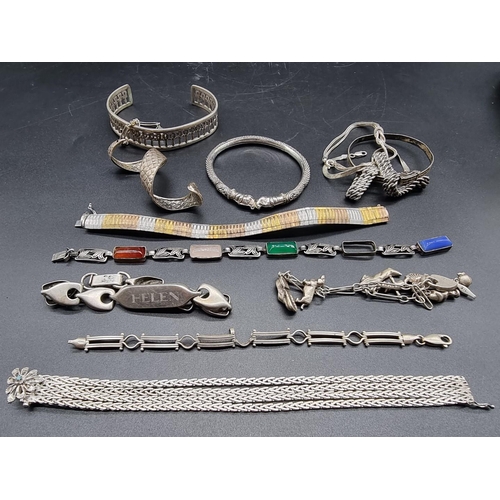 768 - A quantity of silver and white metal bracelets and bangles.