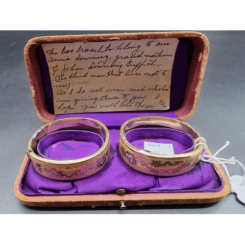 774 - A cased pair of Victorian rolled gold hinged bangles.