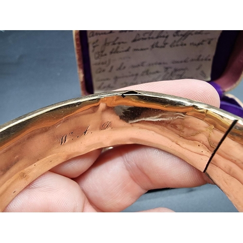 774 - A cased pair of Victorian rolled gold hinged bangles.