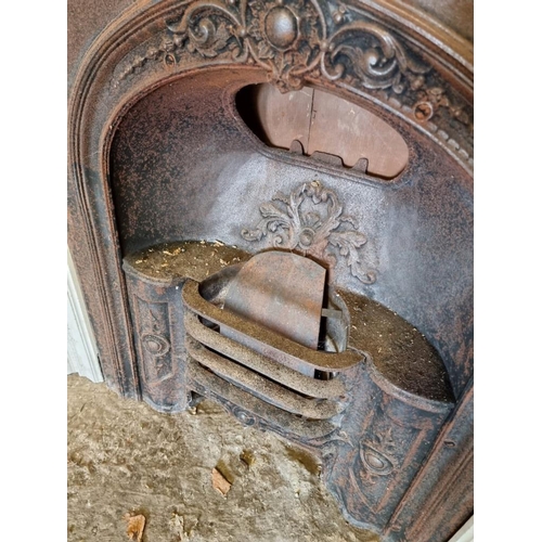 1012 - A cast iron fire surround, 116cm wide x 124cm high; together with a matching fireplace. ... 