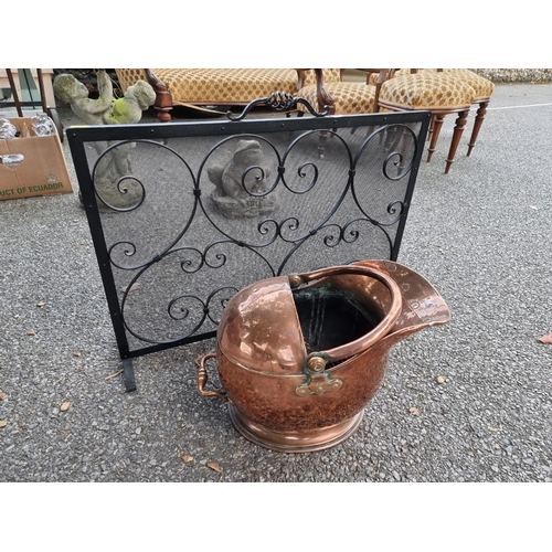 1023 - A metal fireguard; together with a copper coal scuttle.