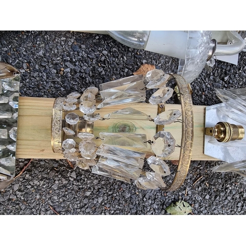 1030 - A set of four glass wall sconces; together with a further set of three gilt metal wall sconces ... 