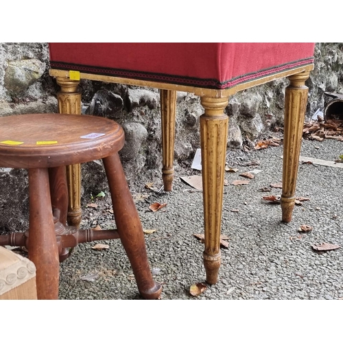 1034 - An antique giltwood and upholstered stool; together with another stool, having gilt brass feet; and ... 