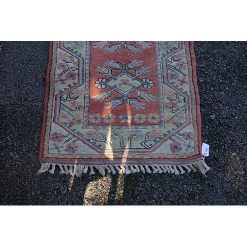 1069 - A Persian runner, having seven central medallions, with floral borders, 271 x 79cm.