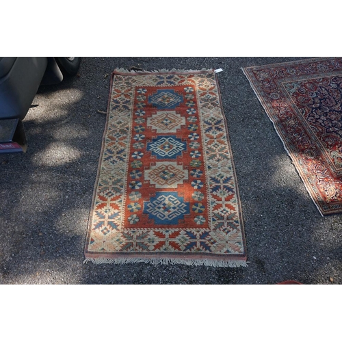 1071 - A Caucasian rug, having five central medallions, 207 x 124cm; together with a smaller example, havin... 