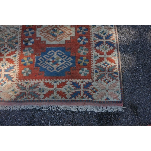 1071 - A Caucasian rug, having five central medallions, 207 x 124cm; together with a smaller example, havin... 