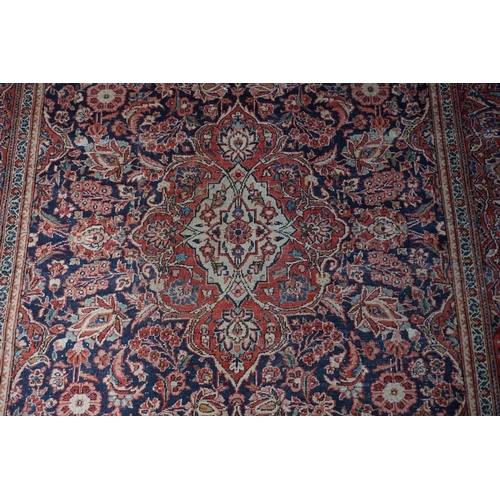 1074 - A pair of Persian rugs, having central floral medallions, with floral borders, with floral borders o... 